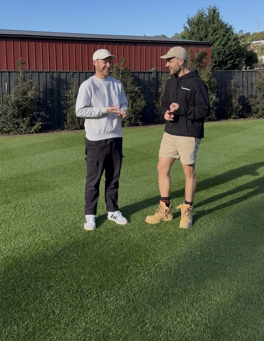 Nick from Lawnsingoodnick and Ben from Lawn Tips standing on a striped lawn